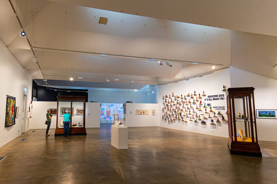 An art gallery with paintings and sculptures on display.