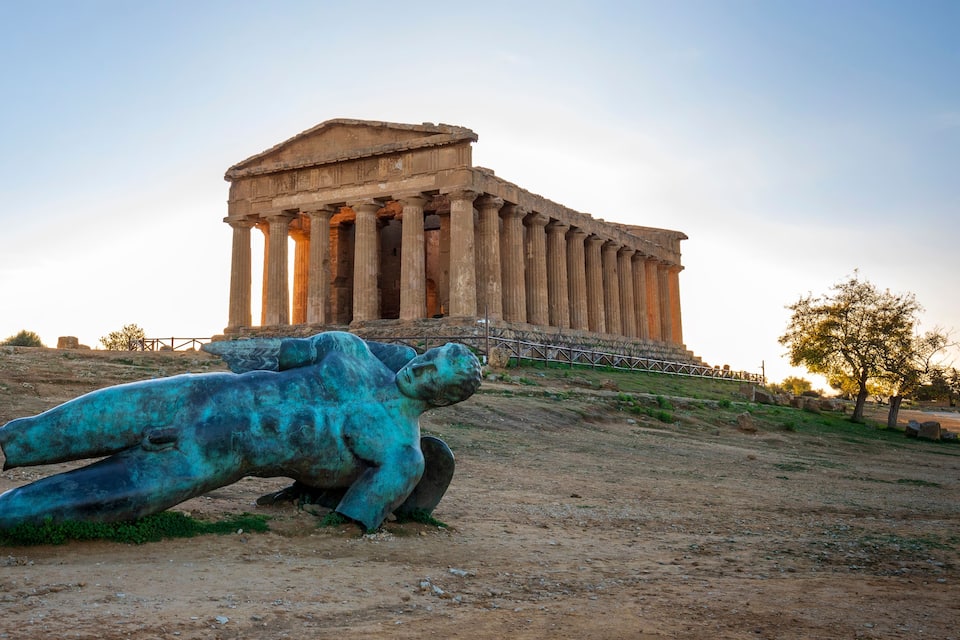 Temple of Concordia and the statue of Fallen Icarus, in the Valley of the Temples, Agrigento, Sicily, Italy