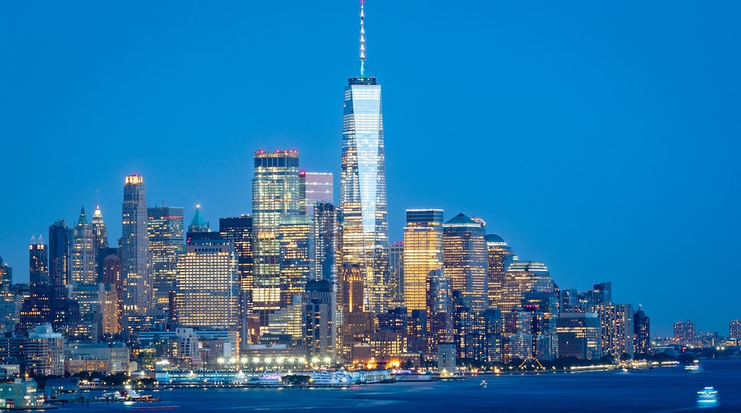 Financial District which includes a bay or harbor, a city and night scenes