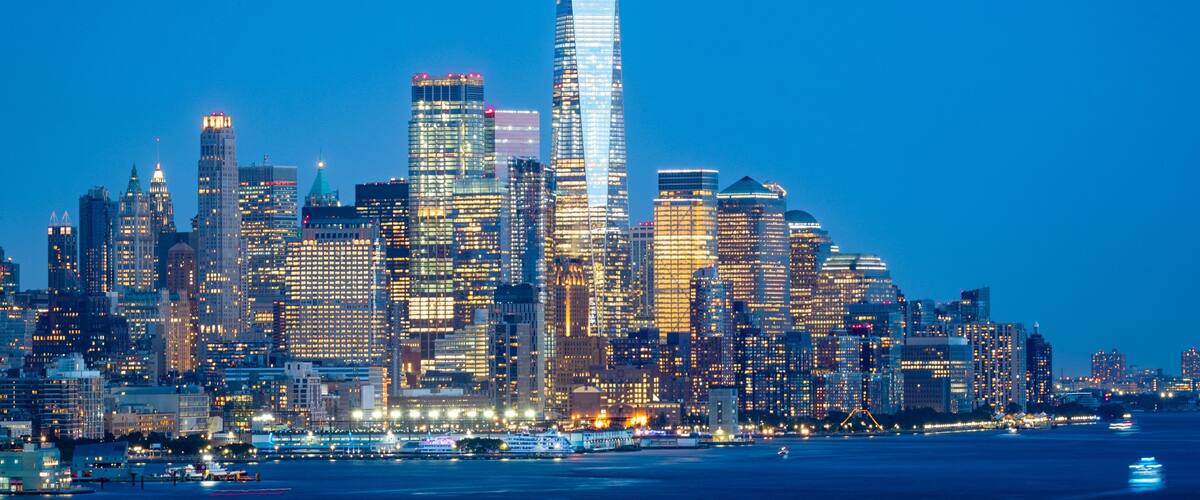 Financial District which includes a bay or harbor, a city and night scenes