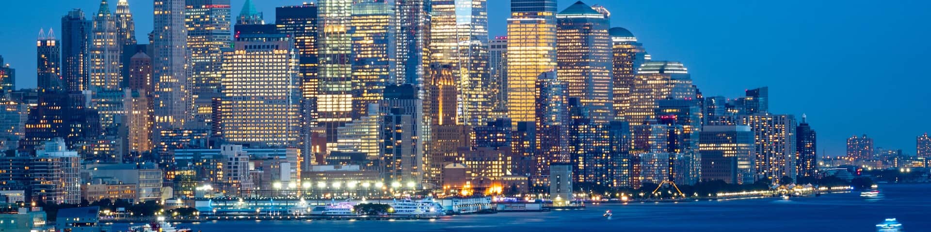 Financial District which includes a bay or harbor, a city and night scenes