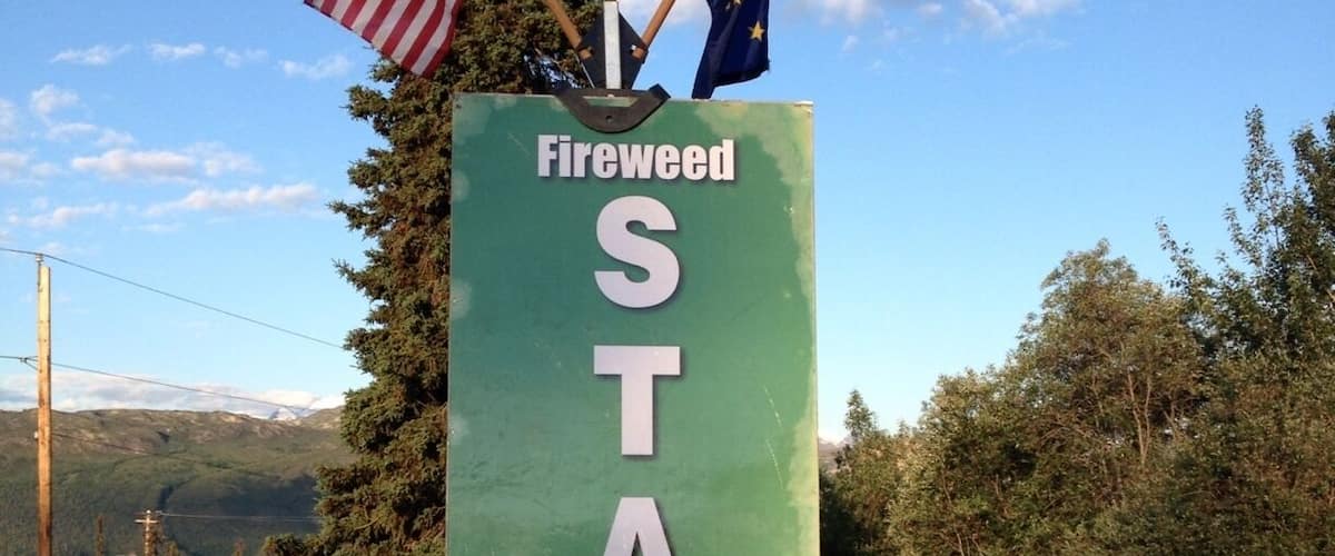 A green sign with 'Fireweed START' and flags.