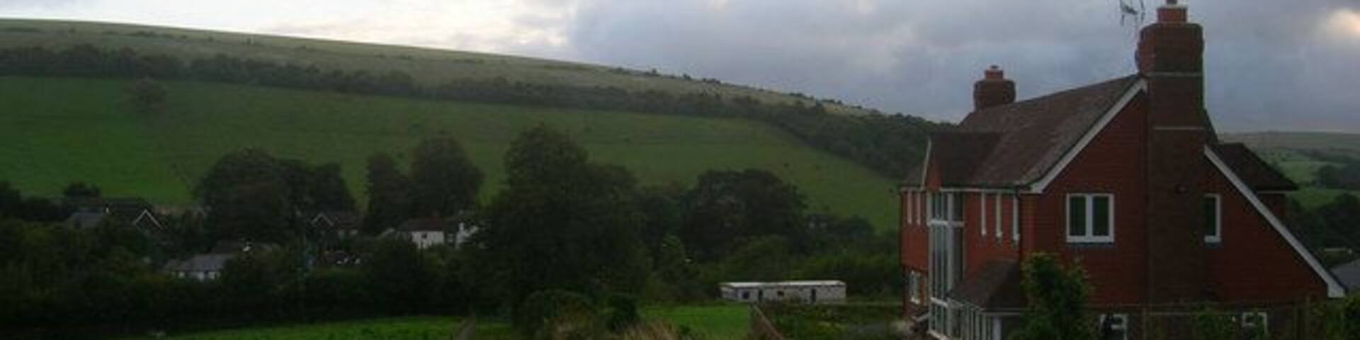 Wayfield Farm The farmhouse is perched on Cowdown Lane now a bridleway linking Pyecombe to Saddlescombe via Newtimber Hill. The houses that cluster around the Pyecombe Street part of the village are in the background whilst the foliage hides the A23 trunk road from view.