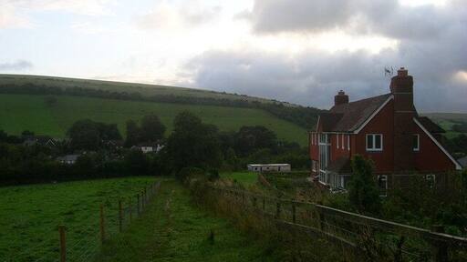 Wayfield Farm The farmhouse is perched on Cowdown Lane now a bridleway linking Pyecombe to Saddlescombe via Newtimber Hill. The houses that cluster around the Pyecombe Street part of the village are in the background whilst the foliage hides the A23 trunk road from view.