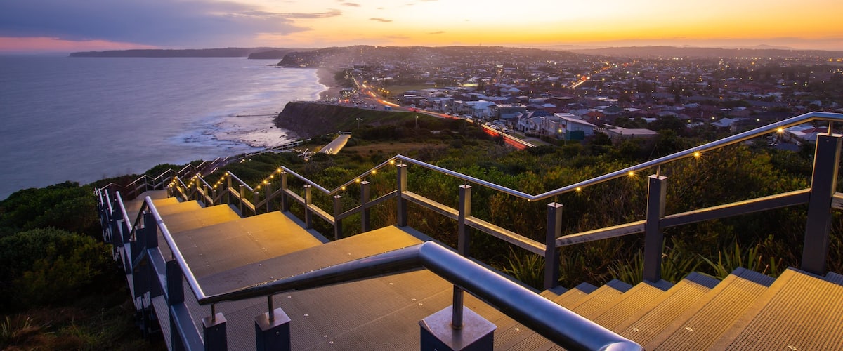 ANZAC Memorial Bridge which includes general coastal views, a sunset and a coastal town