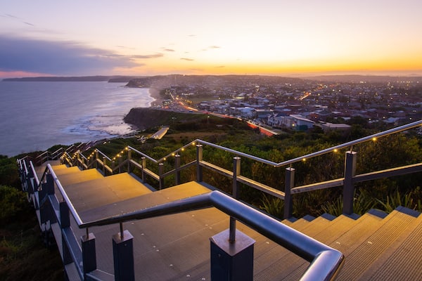 ANZAC Memorial Bridge which includes general coastal views, a sunset and a coastal town
