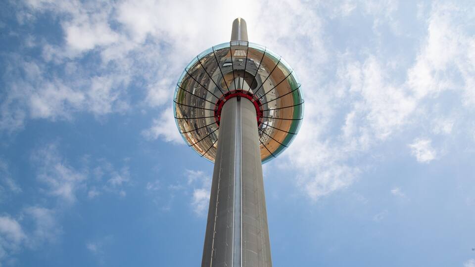 A tall tower with a circular observation deck against a clear sky.