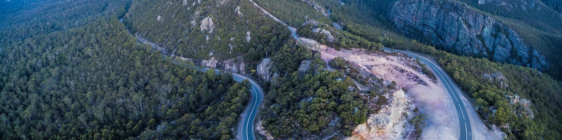 Aerial panorama of Mount Roland Regional Reserve and Olivers road at sunset. Mount Roland, Tasmania, Australia