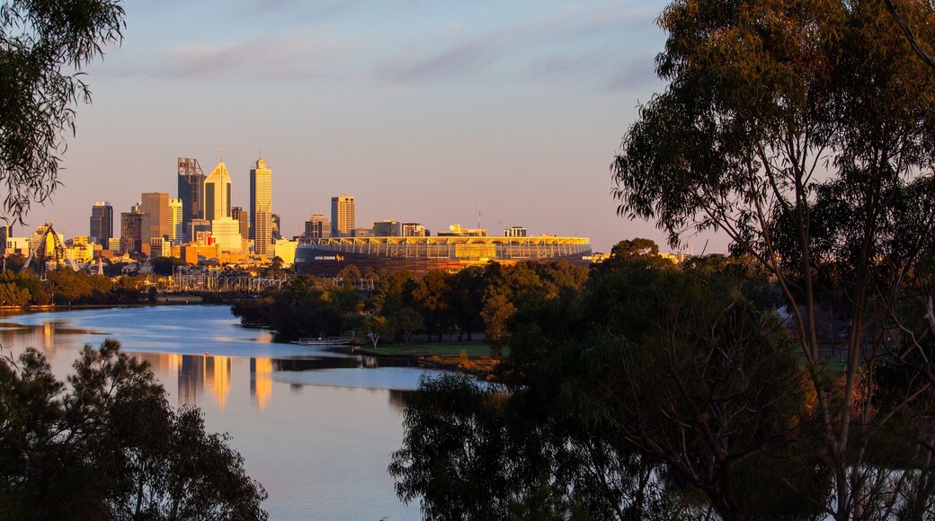 Optus Stadium showing a city, a sunset and a river or creek