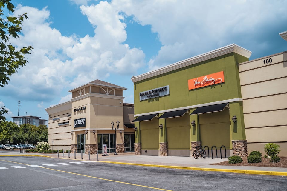 A commercial building with a green facade and a sign that reads "Viva Bradley."