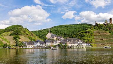 The beautiful village Beilstein in the Moselle valley on a sunny summer day. On a hill above the village are the ruins of Castle Metternich.