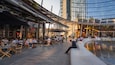 Piazza Gae Aulenti showing outdoor eating and a city as well as a small group of people