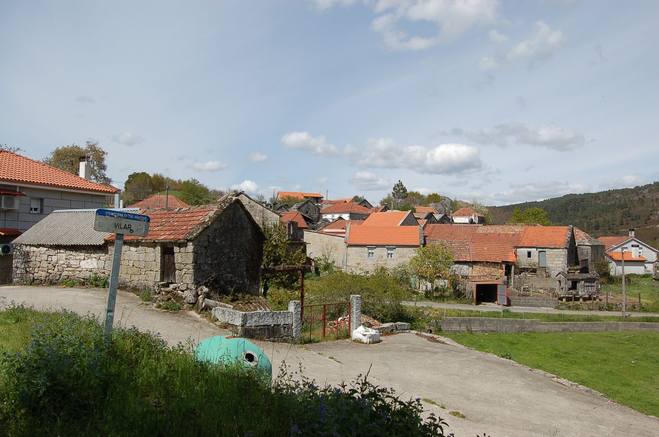 A rural village with stone houses and a sign reading "VILAR".