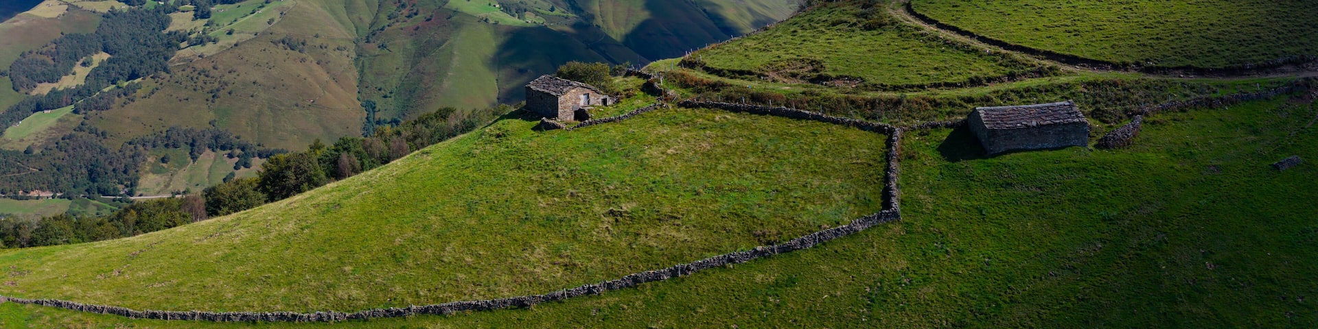 Aerial drone view of the landscape around San Pedro del Romeral. Pas-Miera region. Pasiegos Valleys. Cantabria. Spain. Europe