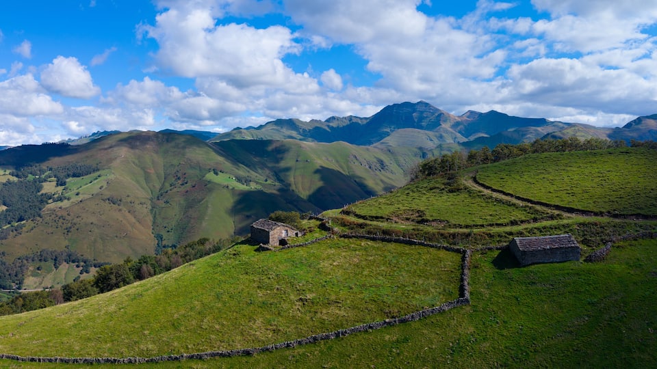 Aerial drone view of the landscape around San Pedro del Romeral. Pas-Miera region. Pasiegos Valleys. Cantabria. Spain. Europe