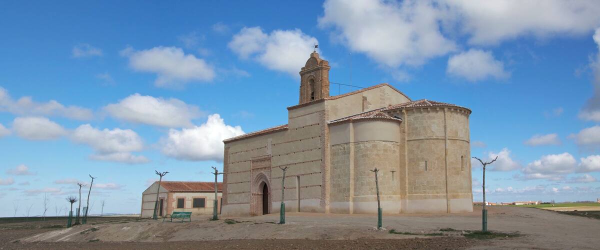A church with a bell tower and a small adjacent building.