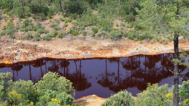 The Río Tinto (« red river »), spanish river of Andalusia (Spain) photographied from the touristic train of the Parque Minero de Riotinto, between Nerva and Berrocal (province of Huelva).