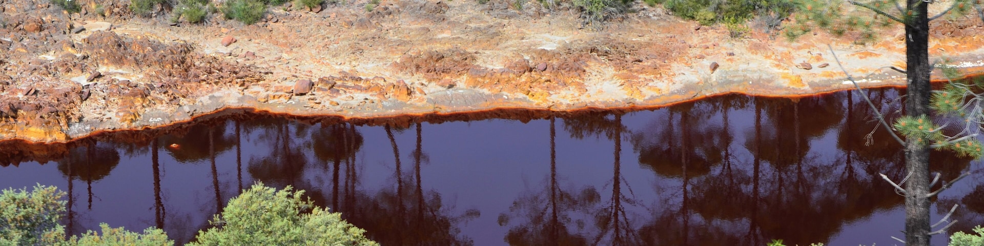 The Río Tinto (« red river »), spanish river of Andalusia (Spain) photographied from the touristic train of the Parque Minero de Riotinto, between Nerva and Berrocal (province of Huelva).