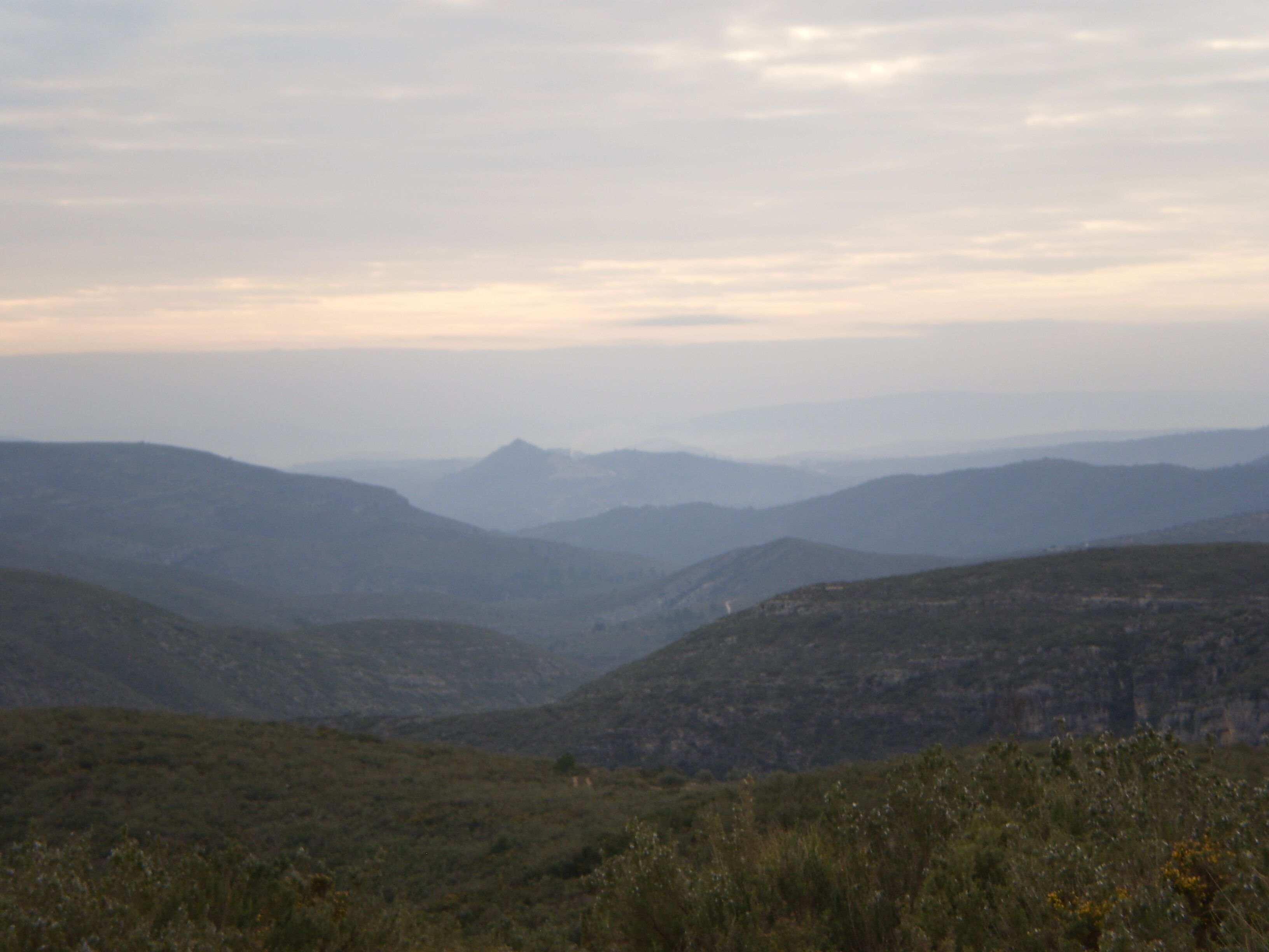 A mountainous landscape with rolling hills and a valley.