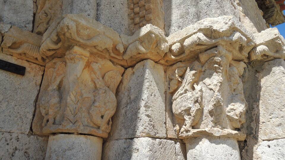 A close-up of ancient stone carvings on a column.