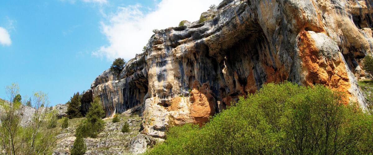 A rugged cliff with a prominent rock formation.