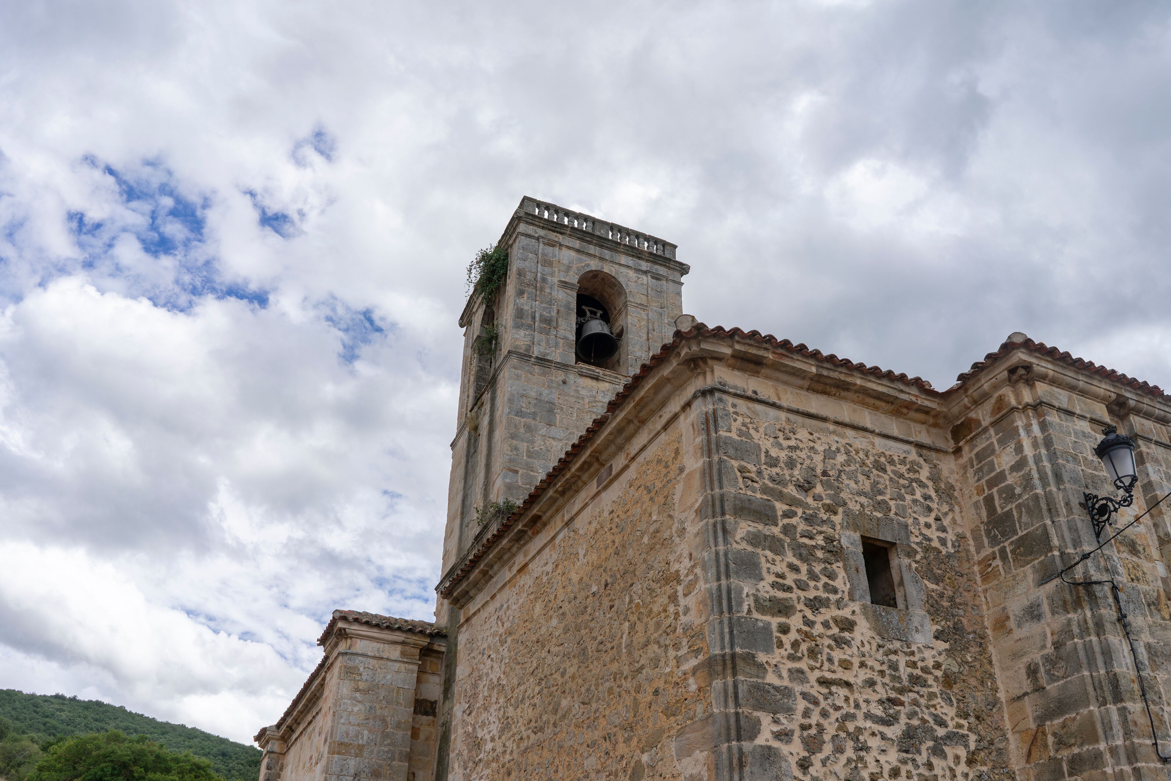 A large stone building with a bell tower. Church of Our Lady of the Assumption. Canales de la S