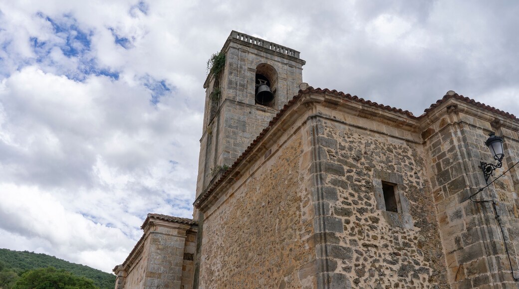A large stone building with a bell tower. Church of Our Lady of the Assumption. Canales de la S
