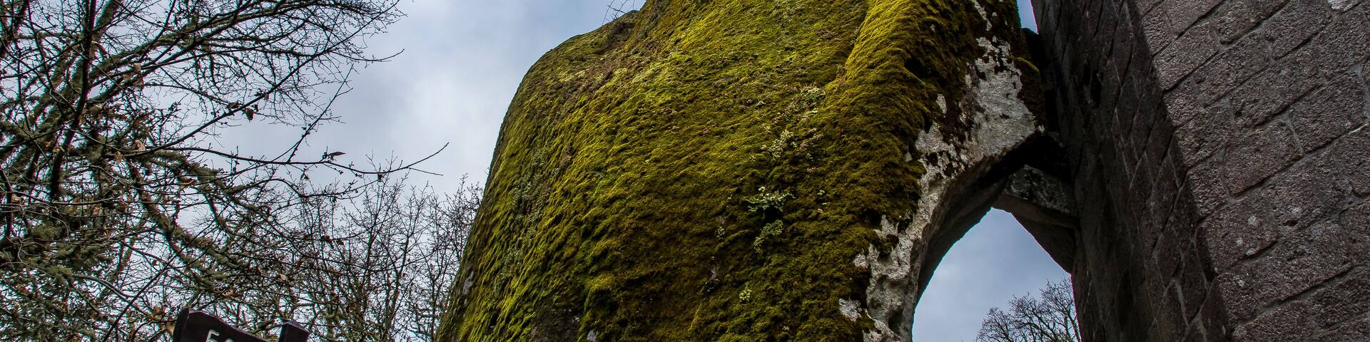 beautiful and very old bell tower on a large rock covered with moss in the romanesque monastery of San Pedro de Rocas, Esgos, Ourense