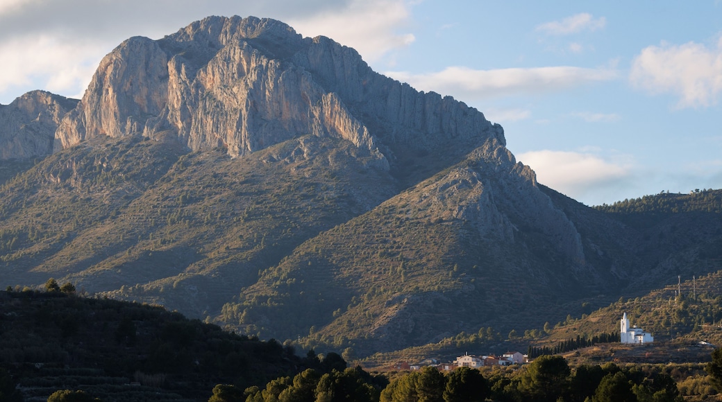 A rugged mountain with a church at its base.