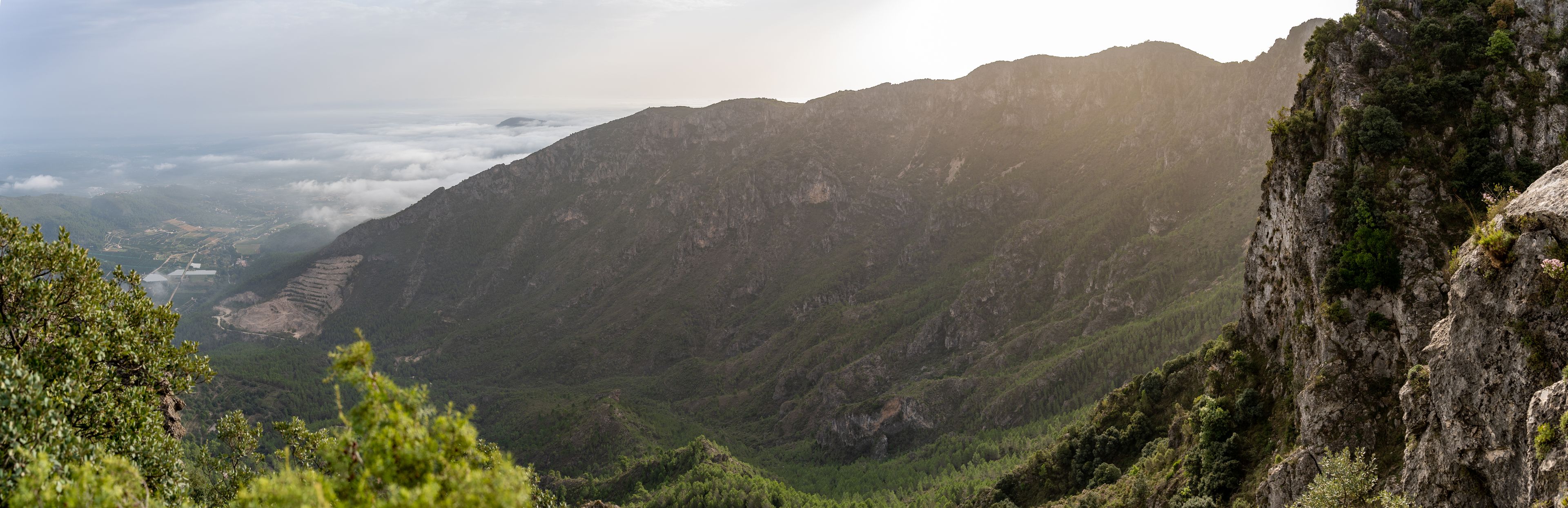 A mountainous landscape with a valley and a cliff.