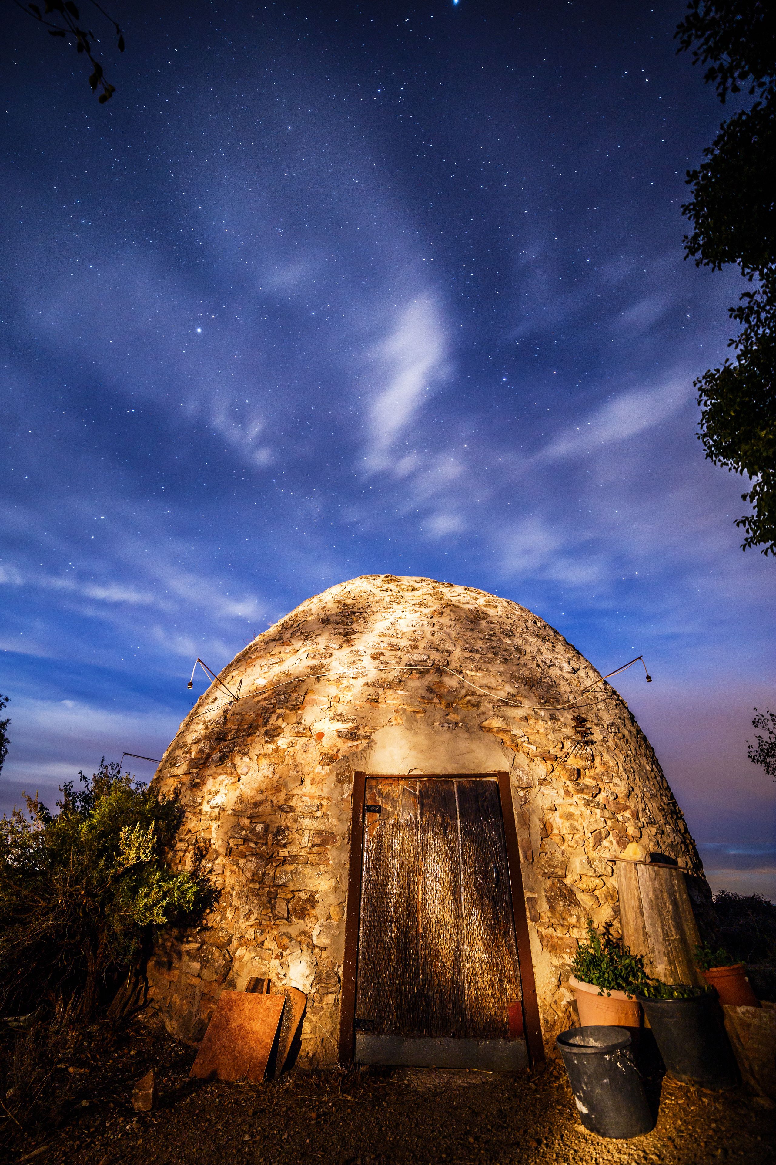A stone dome structure under a starry night sky.