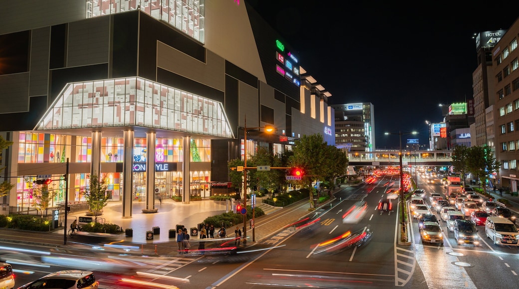 Aeon Mall Okayama which includes night scenes and a city