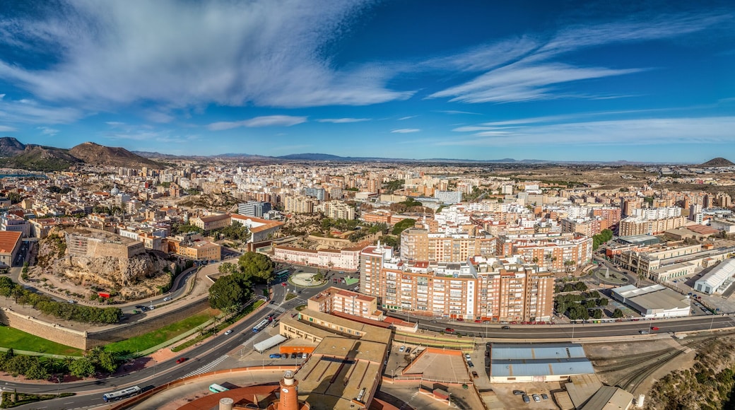 Aerial view of Cartagena port city in Spain surrounded by bastions and fortifications, medieval castle hill, roman amphitheater, bull ring,