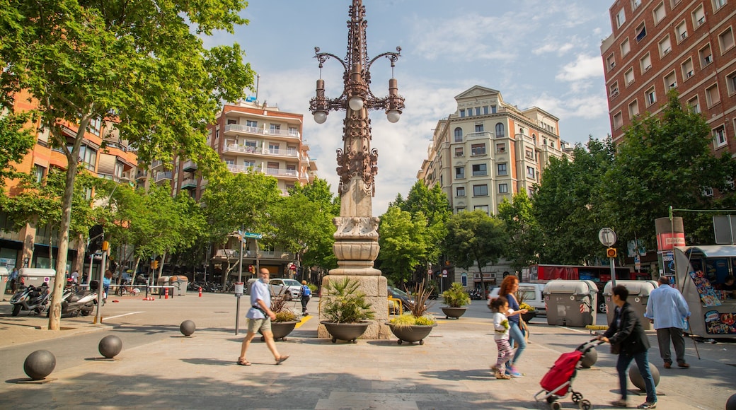 La Sagrada Familia showing outdoor art and street scenes as well as a small group of people