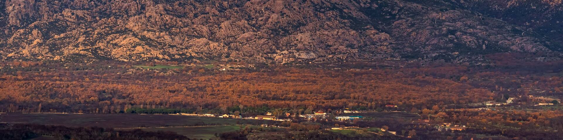 A mountain range with a valley below.