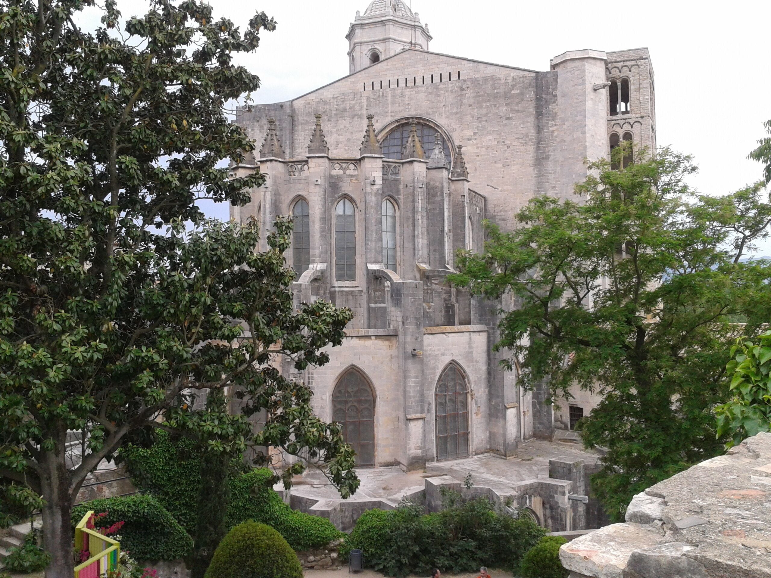 A historic stone church with arched windows and a bell tower.