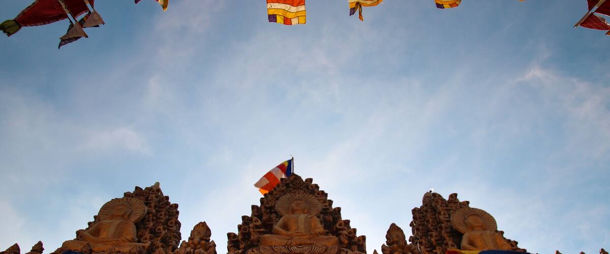 A temple with intricate carvings and a flag on top.