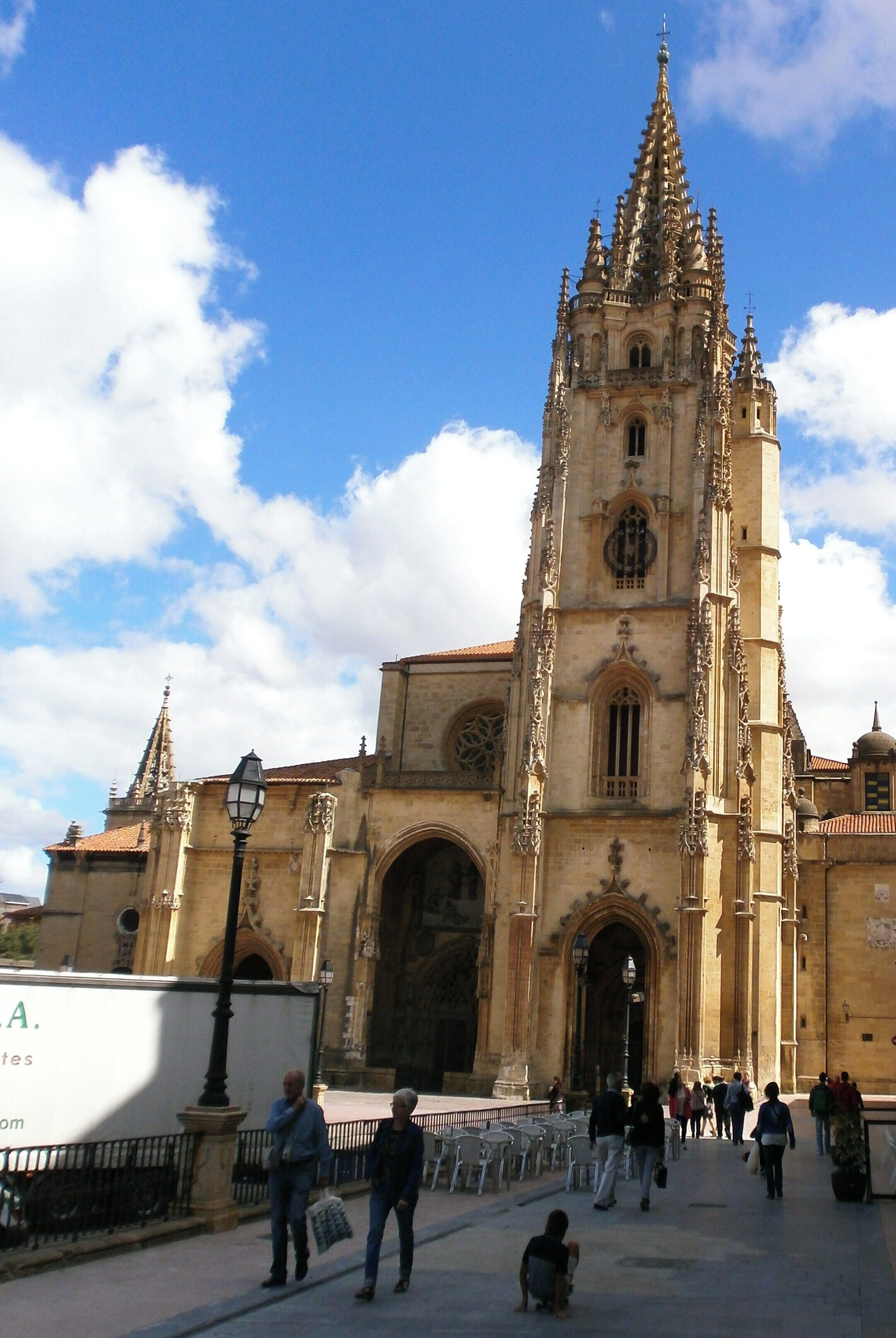 A historic cathedral with a tall spire and intricate architecture.