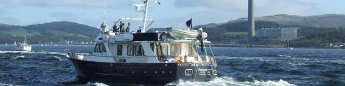 Inverkip Power Station Viewed from MV Saturn as the QE2 sailed up the Clyde for the last time. The boat in the foreground is the Guernsey registered "Dunedin of Kip".