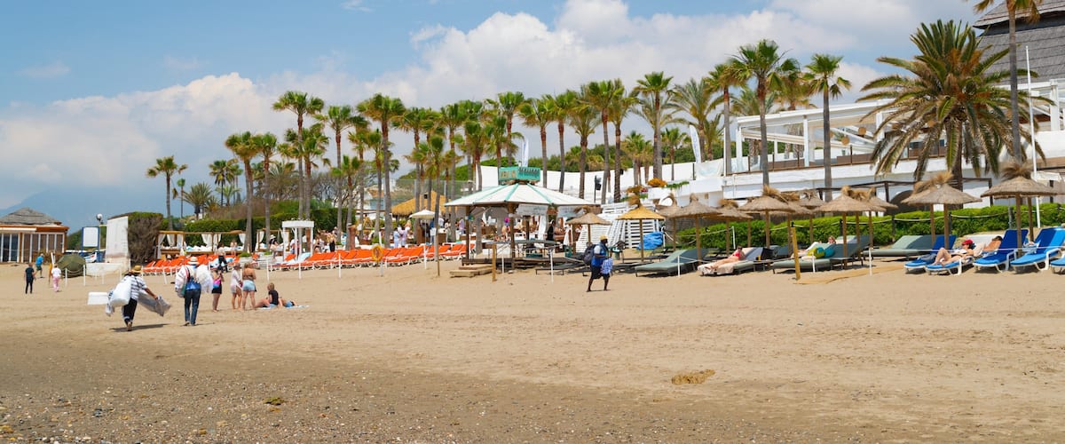 Nikki Beach which includes general coastal views, a sandy beach and a coastal town