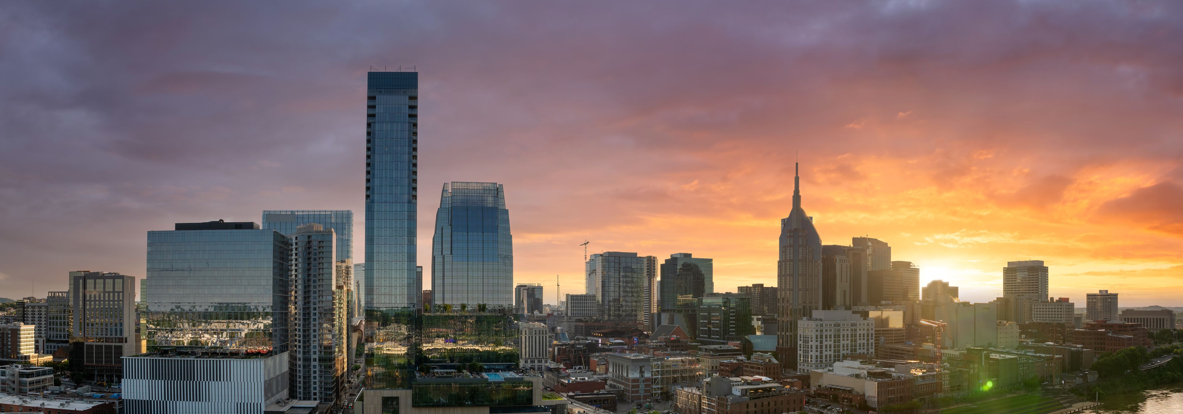 Downtown of Nashville, Tennessee with modern skyline at sunset. Vibrant urban atmosphere in American city.