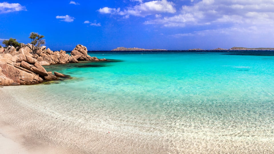 European Caribbean Sardinia Capriccioli beach ultra high resolution panorama with pink sand and turquoise emerald sea Costa Smeralda Italy drone travel destination wide angle landscape