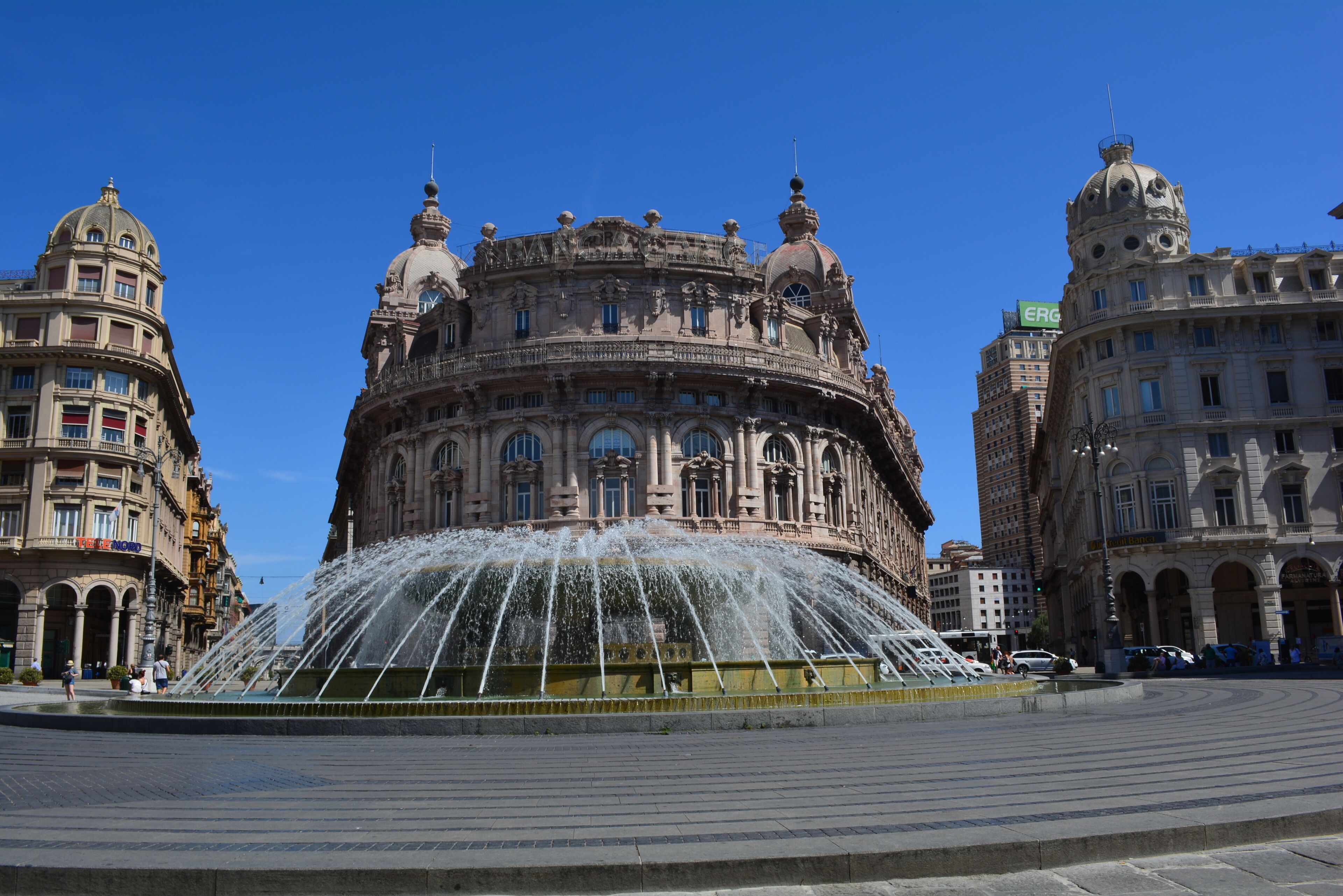 A historic building with ornate architecture and a central fountain.