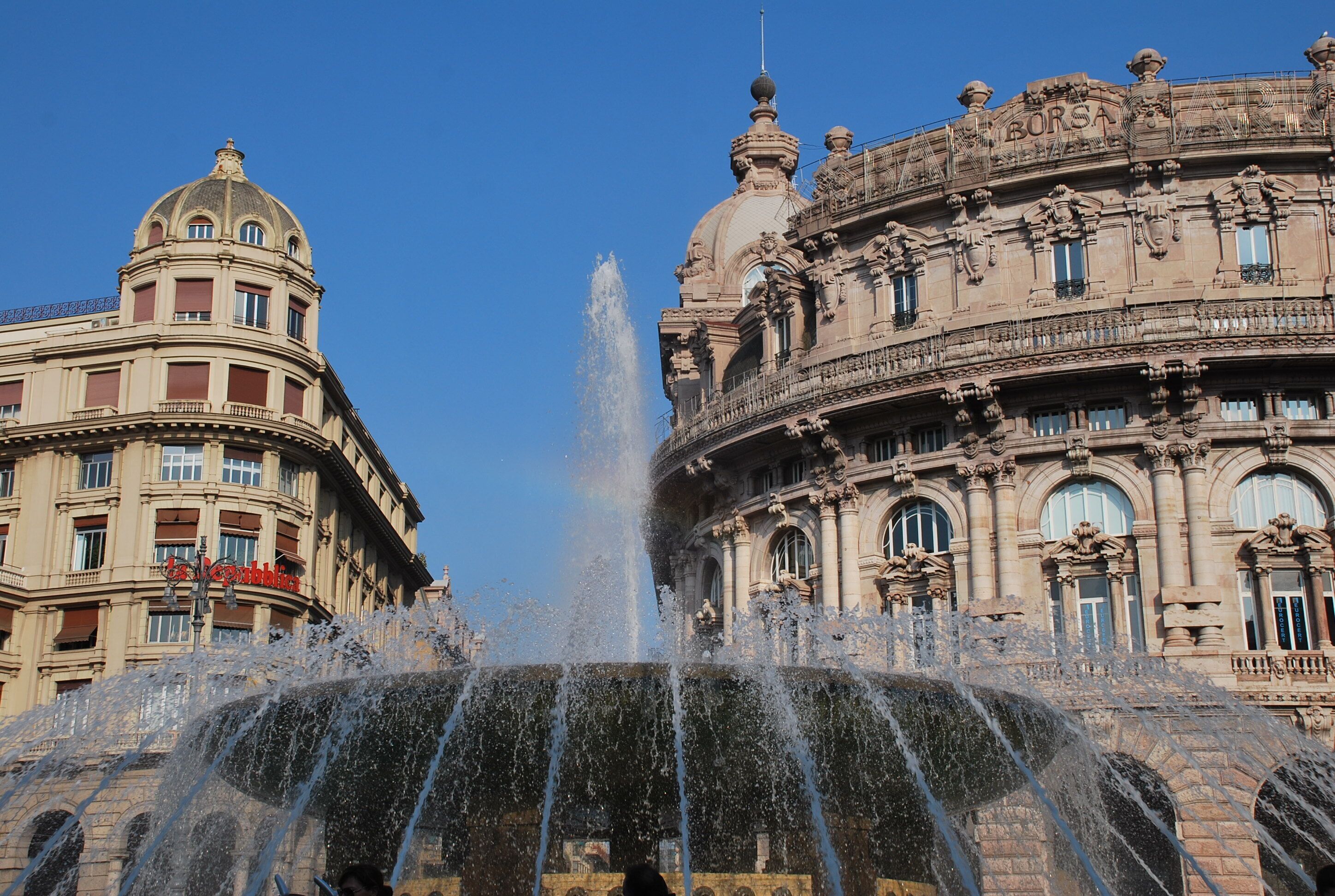 A historic building with ornate architecture and a central fountain.