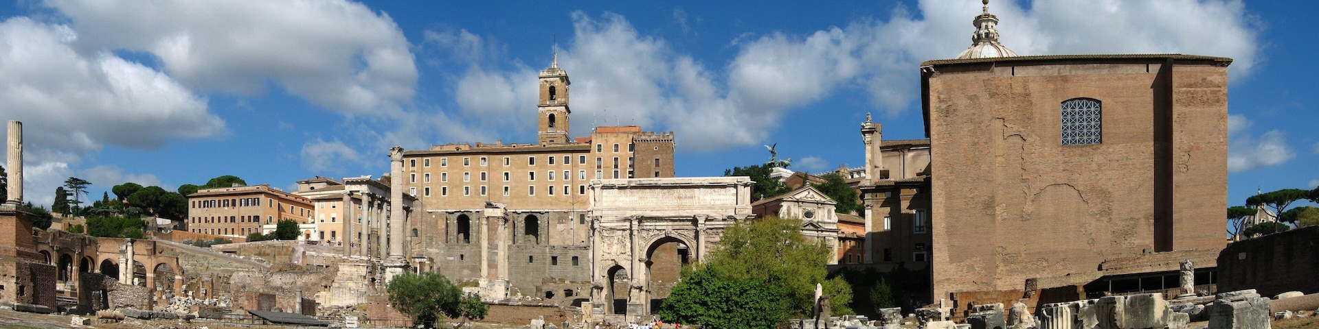 Roman Forum, Rome. The Arch of Septimius Severus stands near the centre of this image. The reconstructed Curia Julia is the large building on the right.