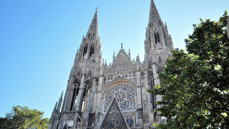 A Gothic cathedral with intricate spires and a large rose window.