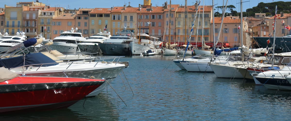 Old city center of Saint-Tropez with harbour and tall ships