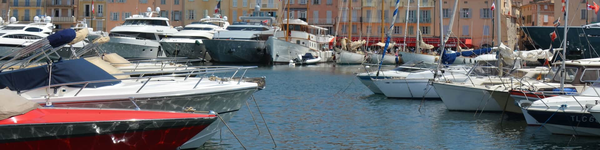 Old city center of Saint-Tropez with harbour and tall ships