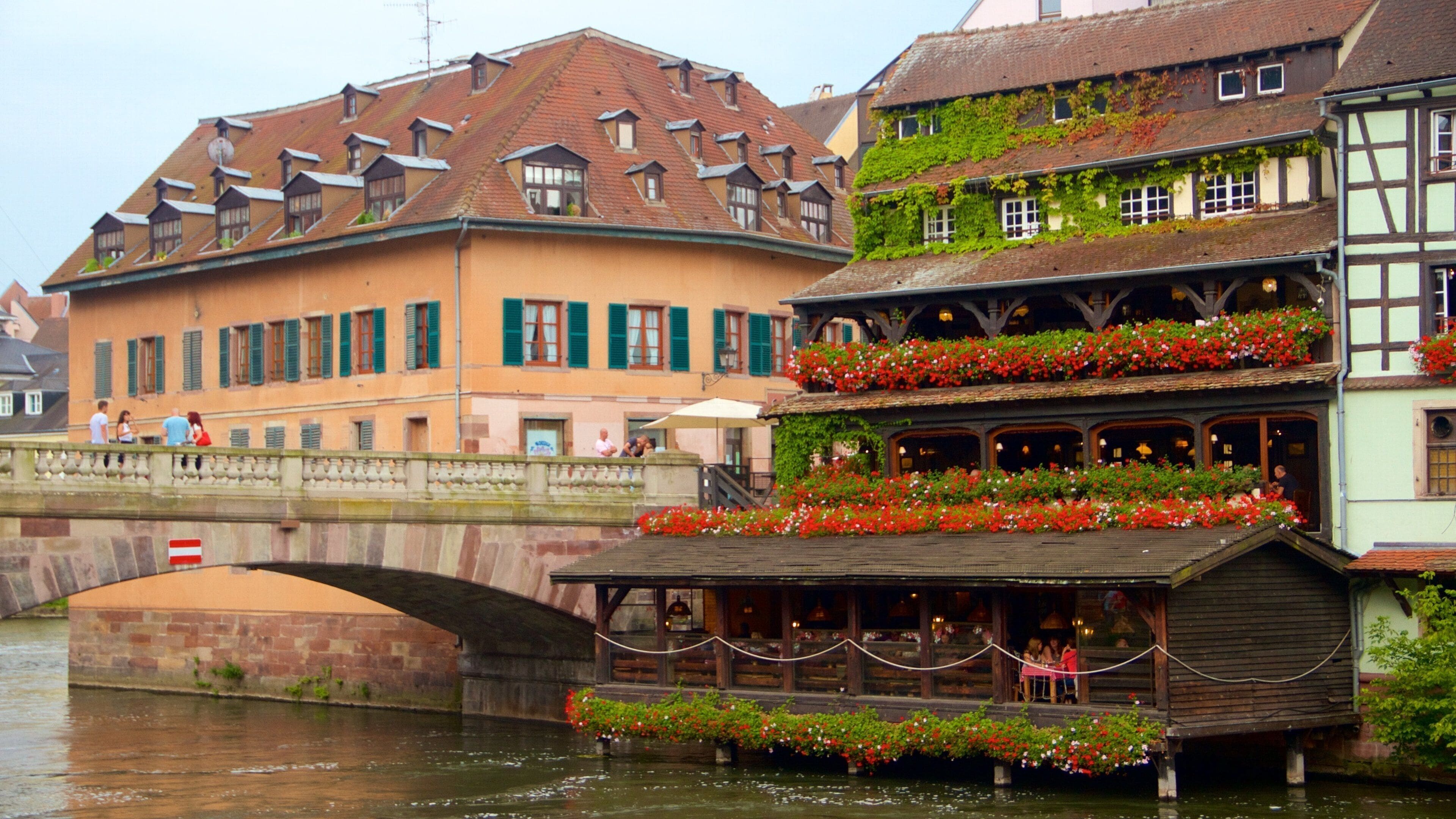 Petite France showing a city, a river or creek and flowers