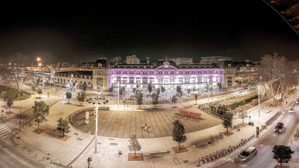 Parvis de la gare Toulouse Matabiau, de nuit avec éclairage de la ville